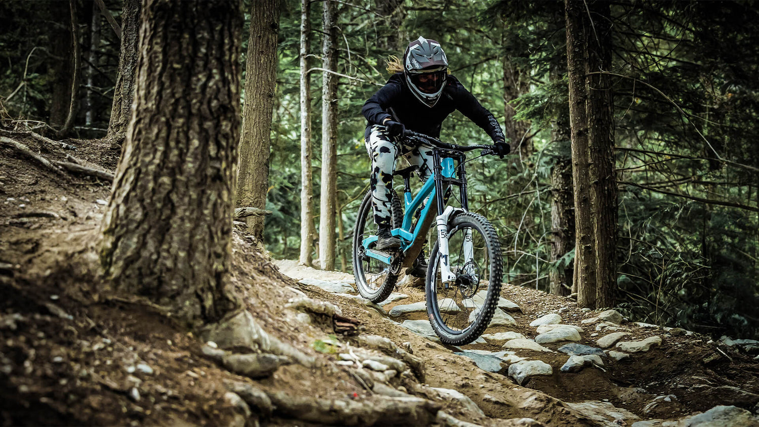 Woman Mountain bike rider wearing the Luxe gear in the forest